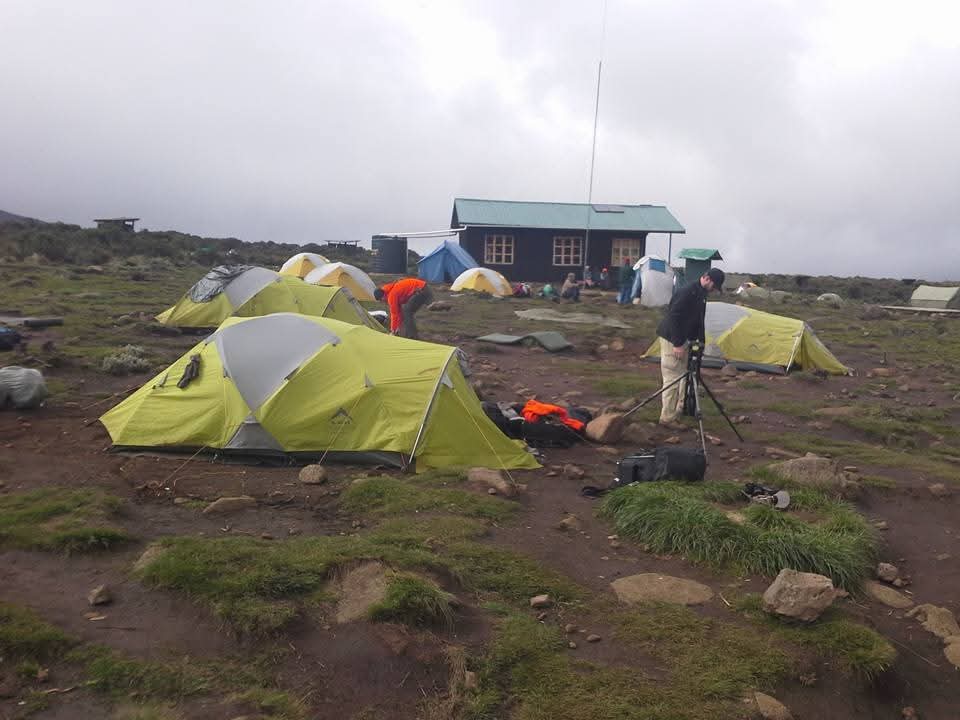 Camp tents beside a mountain hut